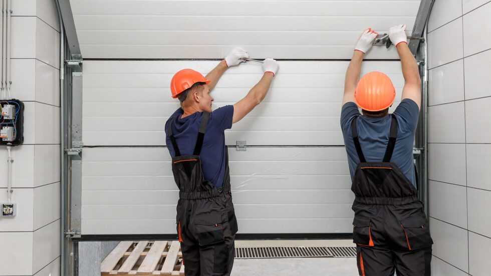 Professional garage door repair technician servicing a residential garage door in Temple, TX